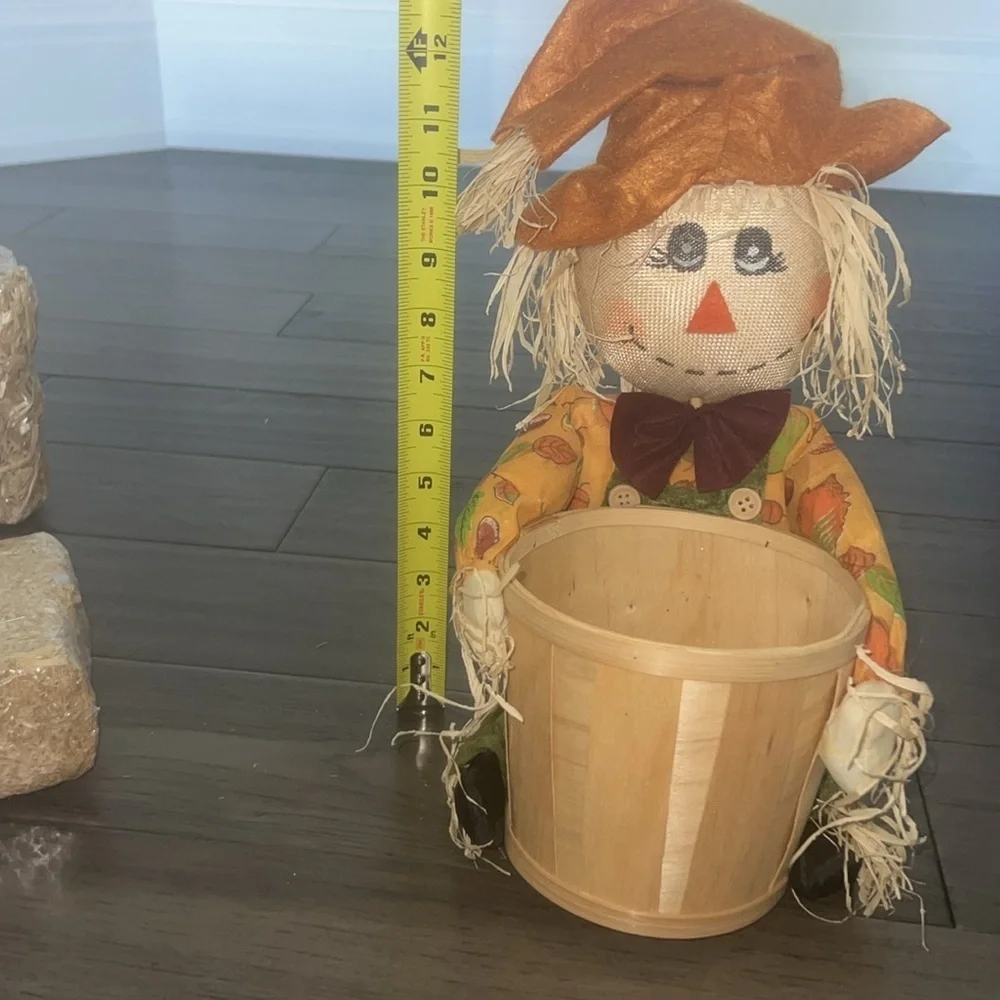 Scarecrow figurine with straw Bale